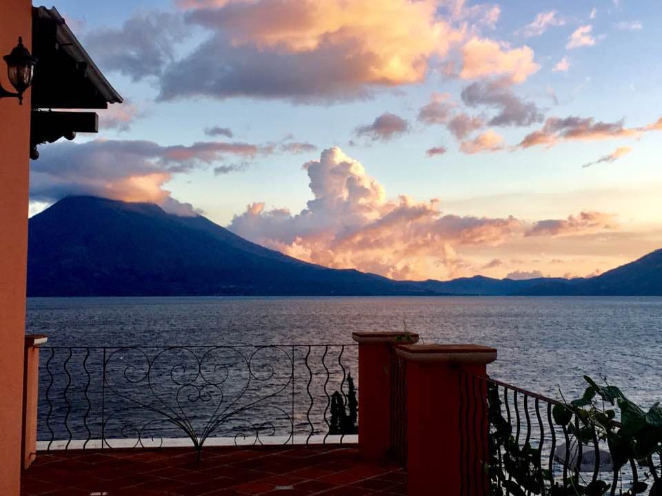 Sunset over the lake seen from a Villas del Carmen terrace, through wrought-iron railings
